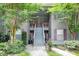 Charming apartment exterior featuring gray siding, stairs, and lush landscaping at 7955 Timbercreek Ln # 1807, North Charleston, SC 29418