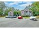 Apartment building with multiple parking spaces and landscaped greenery surrounding the property at 7955 Timbercreek Ln # 1807, North Charleston, SC 29418