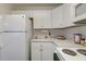 Well-lit kitchen featuring white appliances, cabinetry, and counter tops at 7955 Timbercreek Ln # 1807, North Charleston, SC 29418