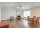 Open-concept living and dining area with fireplace, ceiling fan, and hardwood floors at 7955 Timbercreek Ln # 1807, North Charleston, SC 29418