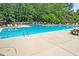 Community pool with plenty of lounge chairs, steps, and ladders for easy access at 7955 Timbercreek Ln # 1807, North Charleston, SC 29418