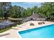 Relaxing pool area with lounge chairs, picnic tables, pond and mature trees at 7955 Timbercreek Ln # 1807, North Charleston, SC 29418