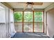 Enclosed screened porch with ceiling fan offering serene views of a pond and greenery at 7955 Timbercreek Ln # 1807, North Charleston, SC 29418