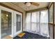 Cozy screened-in porch with ceiling fan, white curtains, and view of trees at 7955 Timbercreek Ln # 1807, North Charleston, SC 29418