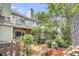 Private backyard with a mix of shade and sun, landscaping, and a balcony above at 8 Town Park Ln # C, Charleston, SC 29412