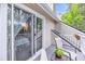 Outdoor balcony features seating, small table, and sliding glass doors to the interior at 8 Town Park Ln # C, Charleston, SC 29412