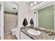 Well-lit bathroom featuring mosaic tile countertop, neutral colors, and an enclosed shower/tub at 8 Town Park Ln # C, Charleston, SC 29412