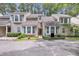 Inviting townhome with beige siding, bay windows, and well-maintained landscaping in a wooded community at 8 Town Park Ln # C, Charleston, SC 29412