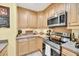 Stylish kitchen with stainless steel appliances, a practical cooktop, and plenty of cabinet storage at 8 Town Park Ln # C, Charleston, SC 29412