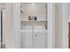 Laundry closet with shelving, full-size washer and dryer, and white doors at 8 Town Park Ln # C, Charleston, SC 29412