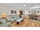 Bright living room featuring hardwood floors, elegant furniture, and a seamless flow to the dining area at 8 Town Park Ln # C, Charleston, SC 29412