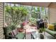 Outdoor patio with comfortable green seating and a grill, nestled in a lush backyard at 8 Town Park Ln # C, Charleston, SC 29412