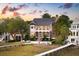 Charming home with lush landscaping, a pool, a walkway to water, and stunning sunset at 80 On The Harbor Dr, Mount Pleasant, SC 29464