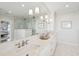 Bathroom with long vanity with double sinks, sconces, and large framed mirror at 80 On The Harbor Dr, Mount Pleasant, SC 29464