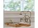 Freestanding tub faucet with a wooden tray featuring soaps and lotions at 80 On The Harbor Dr, Mount Pleasant, SC 29464