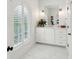 Bright white bathroom featuring a vanity with sink and an arched window with plantation shutters at 80 On The Harbor Dr, Mount Pleasant, SC 29464