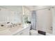 All-white bathroom featuring a bathtub with shower, vanity with sink and window at 80 On The Harbor Dr, Mount Pleasant, SC 29464