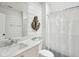 Well-lit bathroom with shiplap walls, modern sink, and a shower with a curtain at 80 On The Harbor Dr, Mount Pleasant, SC 29464