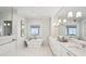 Bright bathroom with freestanding tub, marble countertops, and natural light at 80 On The Harbor Dr, Mount Pleasant, SC 29464