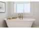 Bright bathroom featuring a soaking tub under a window with natural light at 80 On The Harbor Dr, Mount Pleasant, SC 29464