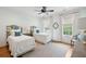 Bright bedroom featuring two beds with decorative headboards, side table and large windows at 80 On The Harbor Dr, Mount Pleasant, SC 29464