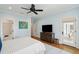 Bright bedroom featuring a ceiling fan, dresser, with access to bathroom and porch at 80 On The Harbor Dr, Mount Pleasant, SC 29464