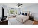 Serene bedroom with a large window seating area, comfortable chair and ceiling fan at 80 On The Harbor Dr, Mount Pleasant, SC 29464