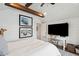Bedroom featuring a bed, white shiplap walls, wood beams and a mounted TV at 80 On The Harbor Dr, Mount Pleasant, SC 29464
