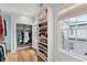 Walk-in closet with floor to ceiling shelving and two windows with coverings at 80 On The Harbor Dr, Mount Pleasant, SC 29464