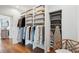 Walk-in closet with custom shelving, hardwood floors, and closet chair at 80 On The Harbor Dr, Mount Pleasant, SC 29464