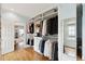 Large walk-in closet with hardwood floors, custom storage, and a mirror at 80 On The Harbor Dr, Mount Pleasant, SC 29464
