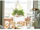 Intimate dining area showcases a natural wood table adorned with greenery near beautiful water views at 80 On The Harbor Dr, Mount Pleasant, SC 29464