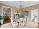 Elegant dining room featuring a chandelier, neutral wallpaper, and hardwood floors at 80 On The Harbor Dr, Mount Pleasant, SC 29464