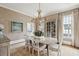 Formal dining room with textured wallpaper, a chandelier, and light-colored furniture at 80 On The Harbor Dr, Mount Pleasant, SC 29464