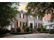 A stately two-story brick home with manicured landscaping and a brick driveway at 80 On The Harbor Dr, Mount Pleasant, SC 29464