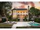 Stunning two-story brick home featuring a covered porch, pool, and lush landscaping at 80 On The Harbor Dr, Mount Pleasant, SC 29464