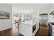Bright kitchen featuring stainless steel appliances, a central island, and a view to a sunlit breakfast nook at 80 On The Harbor Dr, Mount Pleasant, SC 29464