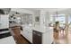 Kitchen island featuring stainless steel dishwasher and deep sink with view into living room at 80 On The Harbor Dr, Mount Pleasant, SC 29464