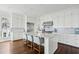 Bright kitchen with central island featuring seating, stainless steel appliances, and classic white cabinetry at 80 On The Harbor Dr, Mount Pleasant, SC 29464