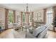 Formal living room featuring a decorative chandelier, neutral furniture, and large windows at 80 On The Harbor Dr, Mount Pleasant, SC 29464