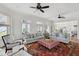 Spacious living room with stylish sofas, chairs, area rug, and water views at 80 On The Harbor Dr, Mount Pleasant, SC 29464