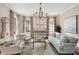 Elegant living room with neutral tones, a statement chandelier, and patterned drapes at 80 On The Harbor Dr, Mount Pleasant, SC 29464