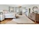 Bright bedroom with ensuite bathroom, hardwood floors and access to private balcony at 80 On The Harbor Dr, Mount Pleasant, SC 29464