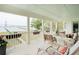 Covered porch with comfortable seating and views of the water and a bridge at 80 On The Harbor Dr, Mount Pleasant, SC 29464