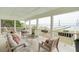 Relaxing porch area with outdoor furniture and scenic water views with bridge at 80 On The Harbor Dr, Mount Pleasant, SC 29464