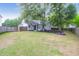 A view of the home's backyard featuring a fence, trees, and partial grass coverage at 8451 Walsham St, North Charleston, SC 29420