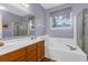 Bathroom featuring double sinks, bathtub, and a separate shower, providing both comfort and functionality at 8451 Walsham St, North Charleston, SC 29420