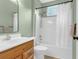 Bathroom features a shower-tub combo with a curtain, complemented by a vanity and stylish fixtures at 8451 Walsham St, North Charleston, SC 29420
