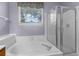Bright bathroom with a combined bathtub and shower and a large window that offers plenty of natural light at 8451 Walsham St, North Charleston, SC 29420
