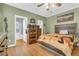 Cozy bedroom with hardwood floors, complemented by rustic wood furniture and an abundance of natural light at 8451 Walsham St, North Charleston, SC 29420